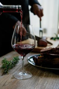 Red wine pouring into a glass