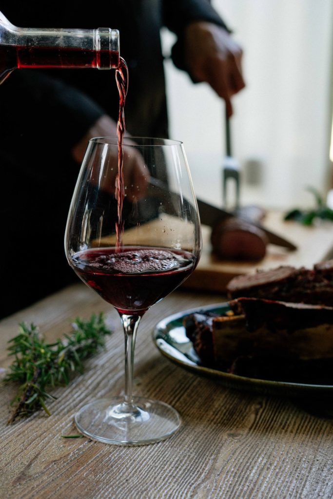 Red wine pouring into a glass